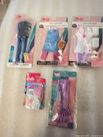 Group shot of five sealed doll clothing/accessory packs