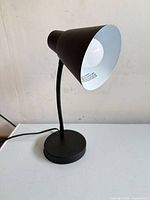 Full view of black desk lamp showing overall design and condition