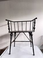 Full view of black Windsor chair showing spindle back and legs