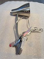 Full view of lamp showing conical shade, gooseneck, clamp and cord