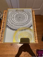 Top view of serving tray showing mirrored surface with tree-ring design and gold trim
