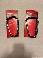 Front view of two packaged Husky 6.25 in cushion-grip carabiners