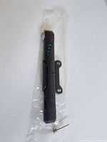 Full view of pump, mounting bracket and needle adapter on plastic sleeve