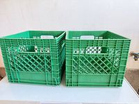 Front view of both green Neilson crates showing handles and lattice sides