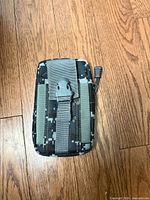 Front view showing digital camo pattern, buckle strap and zipper pull