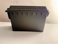 Side view of closed olive drab plastic storage box