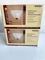 Front of two sealed boxes showing product image and branding
