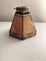 Side view of stained glass lamp shade showing brass fitter and panel detail