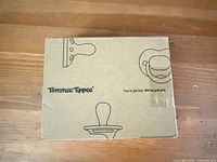 Branded Tommee Tippee cardboard box showing product outline