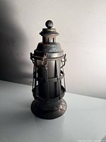 Front three-quarter view of entire lantern showing body, cage and handle