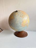 Full view of globe on base showing overall style and colors