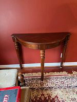 Full view of Bombay demilune console table against wall
