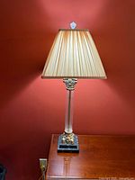 Full view of lamp on table showing shade, column, base