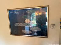 Front view of framed Claude Monet poster on wall