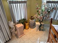 Corner display showing all pedestals, floor vases and arrangements