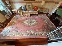 Full view of rectangular pink floral wool rug in room