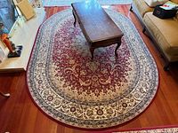 Full view of oval rug under coffee table