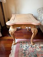Full view of one accent table showing top, legs and painted detail