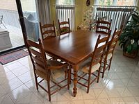 Table with six chairs, leaves retracted