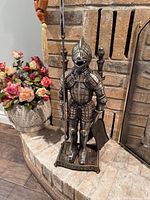 Full view of cast iron knight stand with poker and shovel