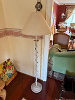 Full view of off-white floor lamp with shade, cord visible