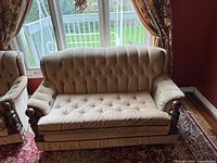 Front view of tufted sofa showing upholstery, tufting and arm details
