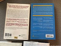 Back covers of two books showing publisher and ISBN data
