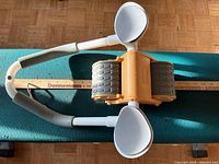 Top view of AB exerciser showing twin wheels, frame, foot pads