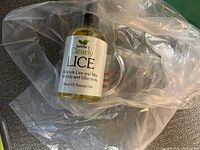 Front view of sealed Isabella's Clearly LICE spray bottle inside plastic