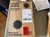 Front of sealed Bright Starts Playful Parade Door Jumper box