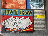 Front covers of three books and water-colour booklet