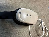 Eye massager side view showing buttons and strap
