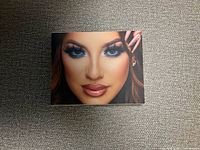 Front of closed palette box featuring face artwork