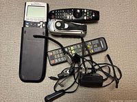 Calculator, digital camera, two remotes, power adapter and cables