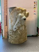 Front view showing giraffe head relief on candle