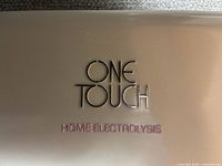 Case lid with One Touch Home Electrolysis branding