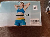Front of sealed Huio Hoop box showing product image of woman using weighted hoop
