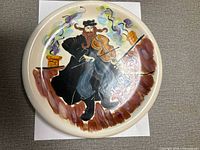Front of plate showing hand-painted Judaica fiddler scene
