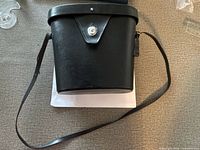 black hard leather carry case with shoulder strap