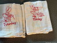 Monday and Tuesday towels showing embroidery