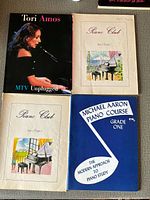 Front covers of four books showing titles and condition