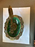 Top view showing brass bowl, green enamel interior, zodiac symbols, SHALOM lever