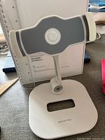Front view of adjustable stand showing brand on base and cradle design