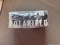 Sealed clear box showing POLARIZED branding