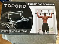Box front showing Topoko pull up bar doorway image and branding