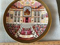Front of plate showing artwork and ruler indicating diameter