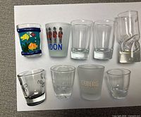 Top view of all nine shot glasses arranged on white background