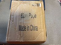 Closed cardboard shipping box marked 85 cm Purple Made in China
