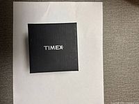Closed black Timex branded box