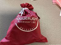 Red Tougerjoy drawstring bag lying flat